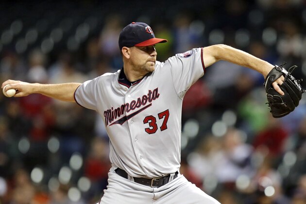 Minnesota Twins pitcher Mike Pelfrey delivers in the first inning of the second baseball game of a doubleheader against the Cleveland Indians, Wednesday, Sept. 30, 2015, in Cleveland. (AP Photo/Tony Dejak)