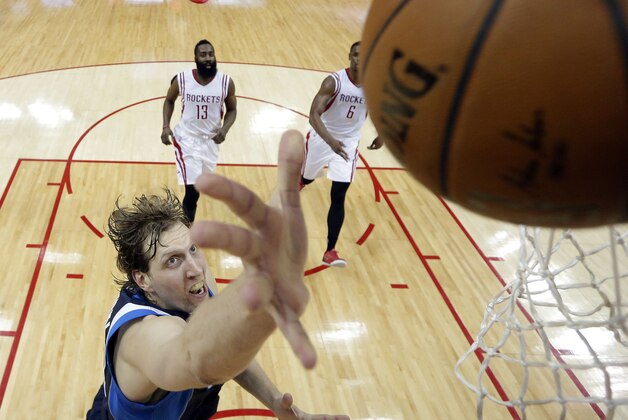 Dallas Mavericks' Dirk Nowitzki (41) puts up a shot during the second half of Game 5 in the first round of the NBA basketball playoffs against the Houston Rockets,Tuesday, April 28, 2015, in Houston. (AP Photo/David J. Phillip)