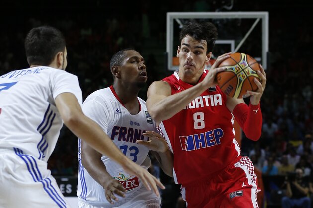 Croatia's Dario Saric, right, drives the ball against France's Boris Diaw, center, and Joffrey Lauvergne during the Group A Basketball World Cup match between Croatia and France in Madrid, Spain, Saturday, Sept. 6, 2014. The 2014 Basketball World Cup competition will take place in various cities in Spain from Aug. 30 through to Sept. 14. (AP Photo/Daniel Ochoa de Olza)