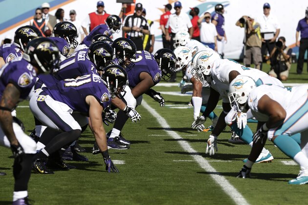 The Miami Dolphins and Baltimore Ravens on the line of scrimmage during the first half of an NFL football game, Sunday, Dec. 7, 2014, in Miami Gardens, Fla. (AP Photo/Wilfredo Lee)