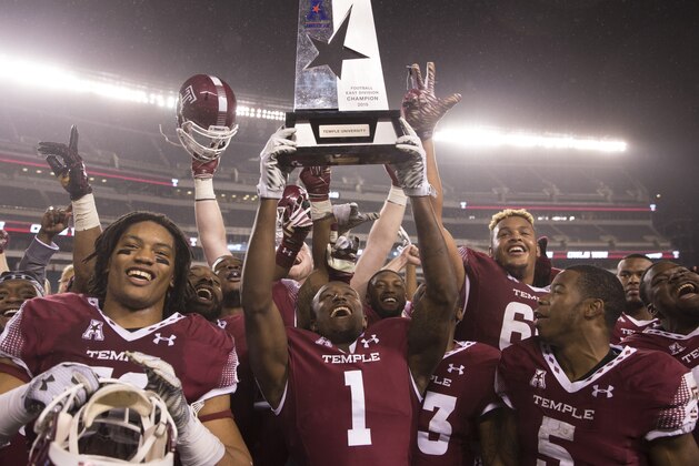 PHILADELPHIA, PA - NOVEMBER 28: Sharif Finch #56, Tavon Young #1, Jahad Thomas #5, and Dion Dawkins #66 of the Temple Owls celebrate with the American Athletic Conference East Division trophy after defeating the Connecticut Huskies on November 28, 2015 at Lincoln Financial Field in Philadelphia, Pennsylvania. The Owls defeated the Huskies 27-3. (Photo by Mitchell Leff/Getty Images)