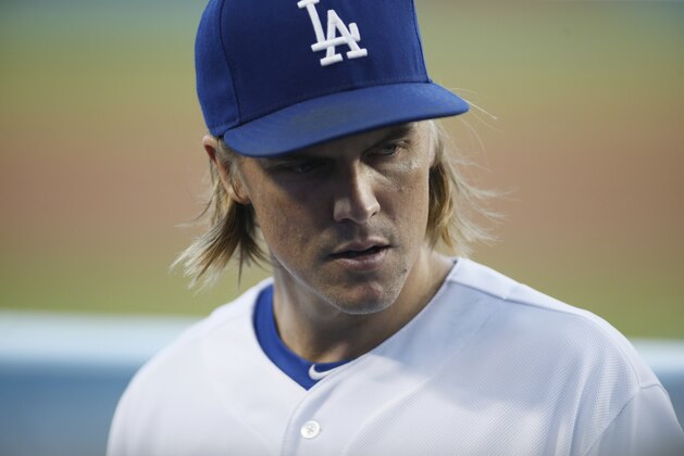 Los Angeles Dodgers starting pitcher Zack Greinke walks into the dugout against the San Diego Padres after the top of the first inning of a baseball game, Saturday, Oct. 3, 2015, in Los Angeles. (AP Photo/Danny Moloshok)