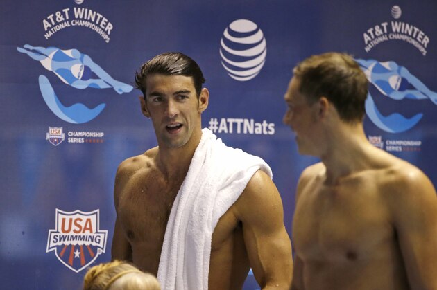 Michael Phelps, left, talks with another swimmer after the men's 100 meter butterfly during a preliminary race in the U.S. Winter Nationals swimming event Friday, Dec. 4, 2015, in Federal Way, Wash. (AP Photo/Elaine Thompson) Michael Phelps, left, talks with another swimmer after the men's 100 meter butterfly during a preliminary race in the U.S. Winter Nationals swimming event Friday, Dec. 4, 2015, in Federal Way, Wash. (AP Photo/Elaine Thompson)