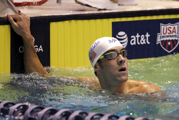 Michael Phelps looks up at the results after swimming in the men's 100 meter butterfly during a preliminary race in the U.S. Winter Nationals swimming event Friday, Dec. 4, 2015, in Federal Way, Wash. (AP Photo/Elaine Thompson) Michael Phelps looks up at the results after swimming in the men's 100 meter butterfly during a preliminary race in the U.S. Winter Nationals swimming event Friday, Dec. 4, 2015, in Federal Way, Wash. (AP Photo/Elaine Thompson)