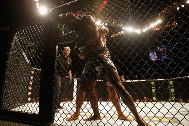 LAS VEGAS, NV - MAY 23:  Rafael Natal of Brazil and Uriah Hall (front) grapple against the Octagon fence in their middleweight bout during the UFC 187 event at the MGM Grand Garden Arena on May 23, 2015 in Las Vegas, Nevada.  (Photo by Christian Petersen/Zuffa LLC/Zuffa LLC via Getty Images)