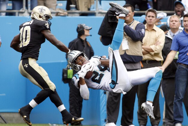 Carolina Panthers' Josh Norman, right, intercepts a pass in front of New Orleans Saints' Brandin Cooks, left, in the second half of an NFL football game in Charlotte, N.C., Sunday, Sept. 27, 2015. The Panthers won 27-22. (AP Photo/Bob Leverone)