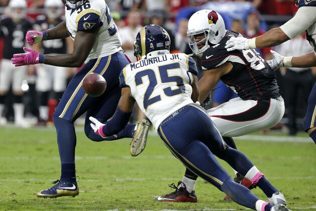 St. Louis Rams strong safety T.J. McDonald (25) recovers a fumble by Arizona Cardinals tight end Jermaine Gresham, right, during the second half of an NFL football game, Sunday, Oct. 4, 2015, in Glendale, Ariz. (AP Photo/Ross D. Franklin)