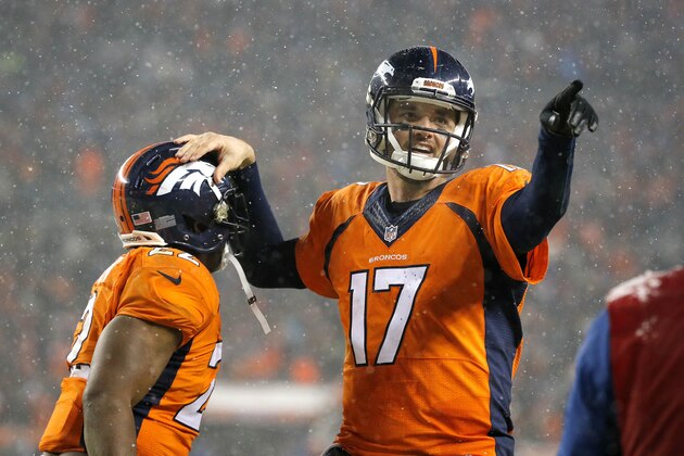 Denver Broncos quarterback Brock Osweiler (17) celebrates his touchdown pass to wide receiver Andre Caldwell, not seen, with Denver Broncos running back C.J. Anderson (22) during the second half of an NFL football game against the New England Patriots, Sunday, Nov. 29, 2015, in Denver. (AP Photo/Jack Dempsey)