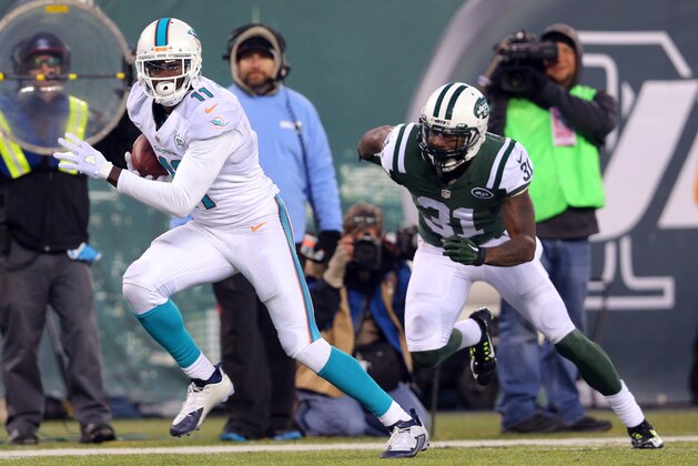 Miami Dolphins wide receiver DeVante Parker (11) runs with the ball against New York Jets corner back Antonio Cromartie (31) during an NFL game at MetLife Stadium in East Rutherford, N.J. on Sunday, Nov. 29, 2015. (AP Photo/Brad Penner)