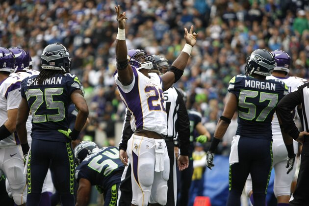 Minnesota Vikings' Adrian Peterson, center, celebrates his second touchdown of the game against the Seattle Seahawks in the first half of an NFL football game, Sunday, Nov. 4, 2012, in Seattle. (AP Photo/John Froschauer)