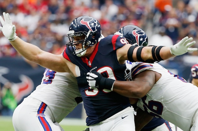HOUSTON, TX - SEPTEMBER 28:  J.J. Watt #99 of the Houston Texans fisghts off two blockers during the third quarter of their game against the Buffalo Bills at NRG Stadium on September 28, 2014 in Houston, Texas.  (Photo by Scott Halleran/Getty Images)