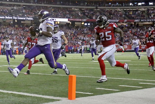 Nov 29, 2015; Atlanta, GA, USA; Minnesota Vikings running back Adrian Peterson (28) runs for a touchdown against Atlanta Falcons strong safety William Moore (25) in the fourth quarter of their game at the Georgia Dome. The Vikings won 20-10. Mandatory Credit: Jason Getz-USA TODAY Sports