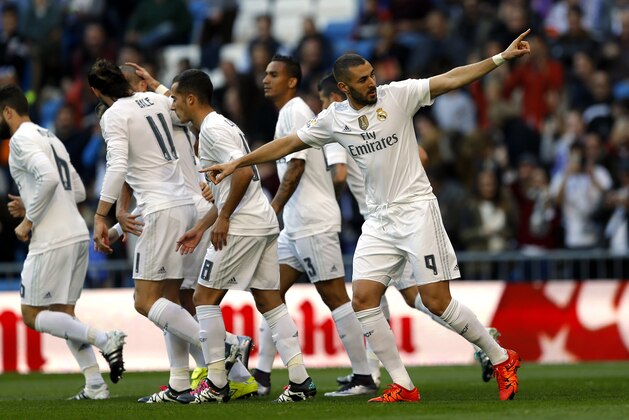 Real Madrid's Karim Benzema, right, celebrates with teammates after scoring the opening goal against Getafe during the Spanish La Liga soccer match between Real Madrid and Getafe at the Santiago Bernabeu stadium in Madrid, Saturday, Dec. 5, 2015. (AP Photo/Francisco Seco)