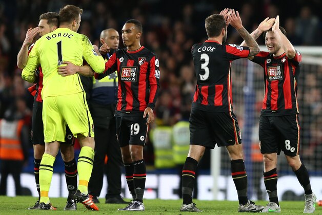 (L-R) Bournemouth's Polish goalkeeper Artur Boruc, Bournemouth's English midfielder Junior Stanislas, Bournemouth's English defender Steve Cook and Bournemouth's English-born Irish midfielder Harry Arter celebrate after winning the English Premier League football match between Chelsea and Bournemouth at Stamford Bridge in London on December 5, 2015.   AFP PHOTO / JUSTIN TALLIS

RESTRICTED TO EDITORIAL USE. No use with unauthorized audio, video, data, fixture lists, club/league logos or 'live' services. Online in-match use limited to 75 images, no video emulation. No use in betting, games or single club/league/player publications. / AFP / JUSTIN TALLIS        (Photo credit should read JUSTIN TALLIS/AFP/Getty Images)