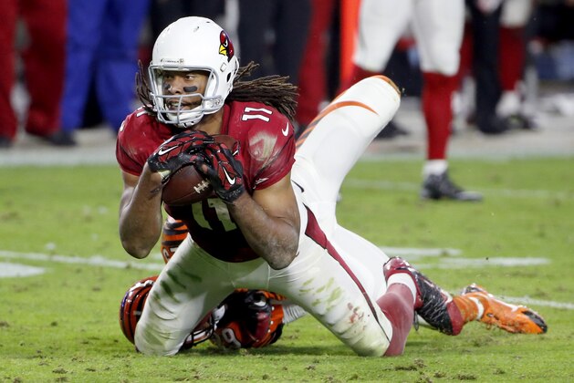 Arizona Cardinals wide receiver Larry Fitzgerald (11) his hit by Cincinnati Bengals strong safety Leon Hall (29) an NFL football game, Sunday, Nov. 22, 2015, in Glendale, Ariz. The Cardinals won 34-31. (AP Photo/Ross D. Franklin)