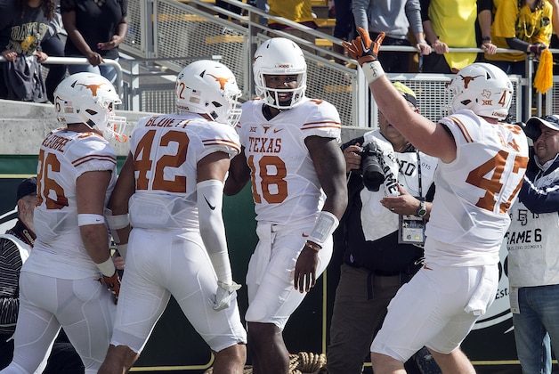 Dec 5, 2015; Waco, TX, USA; Texas Longhorns tight end Alex De La Torre (36) and tight end Caleb Bluiett (42) and quarterback Tyrone Swoopes (18) and tight end Andrew Beck (47) celebrate Swoopes' touchdown against the Baylor Bears  during the first quarter at McLane Stadium. Mandatory Credit: Jerome Miron-USA TODAY Sports