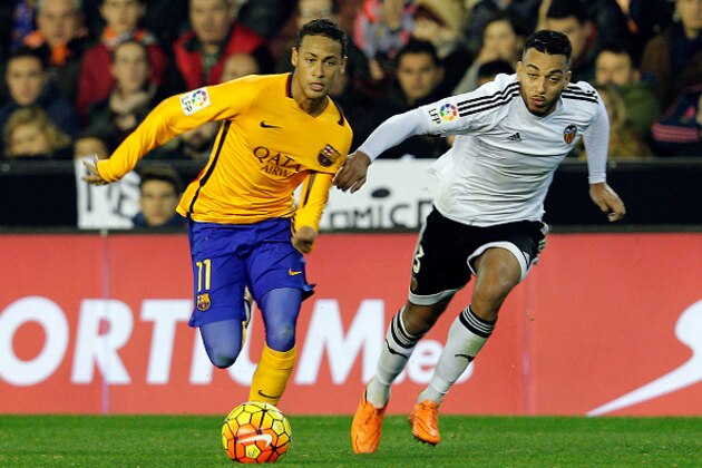 Barcelona's Brazilian forward Neymar (L) vies with Valencia's Portuguese defender Ruben Vezo during the Spanish league football match Valencia CF vs FC Barcelona at the Mestalla stadium in Valencia on December 5, 2015. AFP PHOTO / JOSE JORDAN / AFP / JOSE JORDAN        (Photo credit should read JOSE JORDAN/AFP/Getty Images)