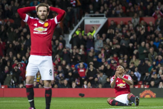 Manchester United's Anthony Martial, right, and Juan Mata react after a missed opportunity during the English Premier League soccer match between Manchester United and West Ham United at Old Trafford Stadium, Manchester, England, Saturday, Dec. 5, 2015. (AP Photo/Jon Super)