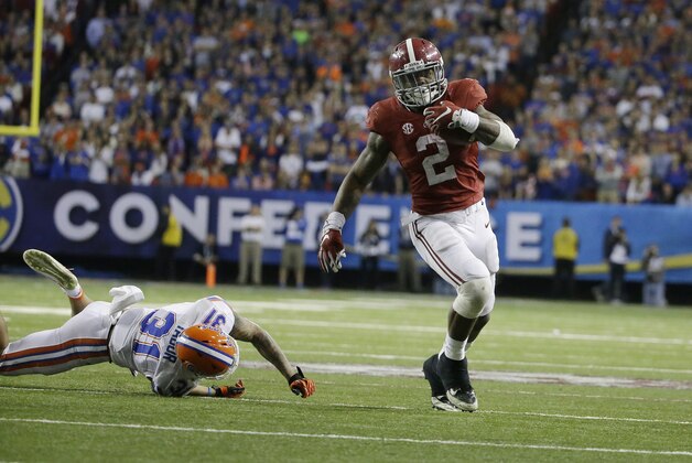 Alabama running back Derrick Henry (2) runs by Florida defensive back Jalen Tabor (31) during the second half of the Southeastern Conference championship NCAA college football game, Saturday, Dec. 5, 2015, in Atlanta. (AP Photo/David Goldman)