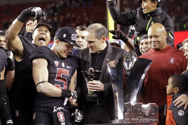 Pac-12 Commissioner Larry Scott, center, presents the MVP trophy to Stanford's Christian McCaffrey (5) after Stanford defeated Southern California 41-22 in the Pac-12 championship football game Saturday, Dec. 5, 2015, in Santa Clara, Calif. At right is Stanford coach David Shaw. (AP Photo/Ben Margot)