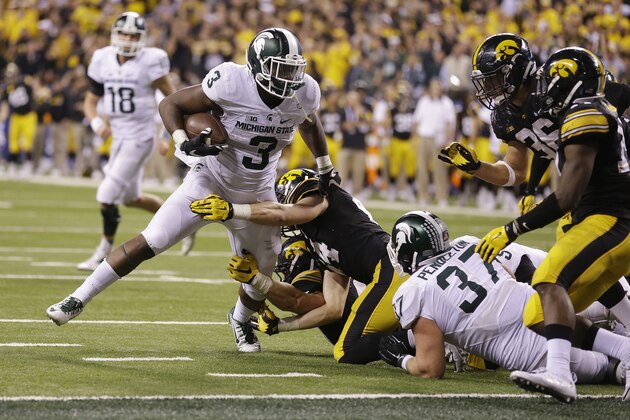 Michigan State's LJ Scott (3) runs for a 1-yard touchdown during the second half of the Big Ten championship NCAA college football game against Iowa, Saturday, Dec. 5, 2015, in Indianapolis. Michigan State won 16-13. (AP Photo/Michael Conroy)