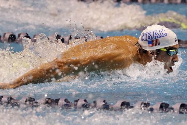 Michael Phelps swims in the men's 100 meter butterfly during a preliminary race in the U.S. Winter Nationals swimming event Friday, Dec. 4, 2015, in Federal Way, Wash. (AP Photo/Elaine Thompson)