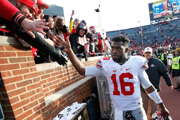 ANN ARBOR, MI - NOVEMBER 28:  J.T. Barrett #16 of the Ohio State Buckeyes celebrates with fans after a 42-13 win over the Michigan Wolverines at Michigan Stadium on November 28, 2015 in Ann Arbor, Michigan.  (Photo by Gregory Shamus/Getty Images)
