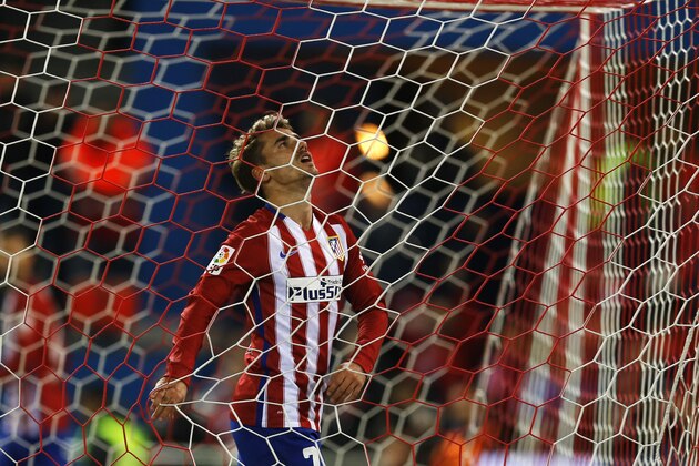 Atletico Madrid's Antoine Griezmann reacts inside the goal during a Spanish La Liga soccer match between Atletico Madrid and Espanyol at the Vicente Calderon stadium in Madrid, Saturday, Nov. 28, 2015.  Griezmann scored once in Atletico's 1-0 victory. (AP Photo/Francisco Seco)