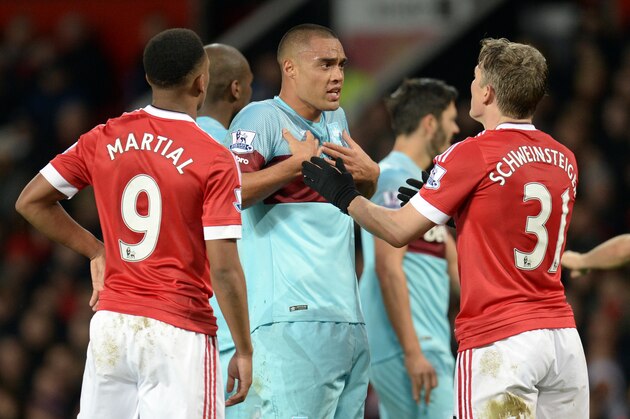 West Ham United's New Zealand defender Winston Reid (C) gets heated with Manchester United's German midfielder Bastian Schweinsteiger during the English Premier League football match between Manchester United and West Ham United at Old Trafford in Manchester, north west England, on December 5, 2015.  AFP PHOTO / OLI SCARFF

RESTRICTED TO EDITORIAL USE. No use with unauthorized audio, video, data, fixture lists, club/league logos or 'live' services. Online in-match use limited to 75 images, no video emulation. No use in betting, games or single club/league/player publications. / AFP / OLI SCARFF        (Photo credit should read OLI SCARFF/AFP/Getty Images)