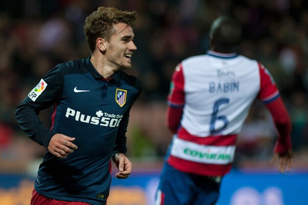 Atletico Madrid's French forward Antoine Griezmann celebrates after scoring during the Spanish league football match Granada FC VS Club Atletico de Madrid at Nuevo Los Carmenes stadium in Granada on December 5, 2015.   AFP PHOTO / JORGE GUERRERO / AFP / Jorge Guerrero        (Photo credit should read JORGE GUERRERO/AFP/Getty Images)