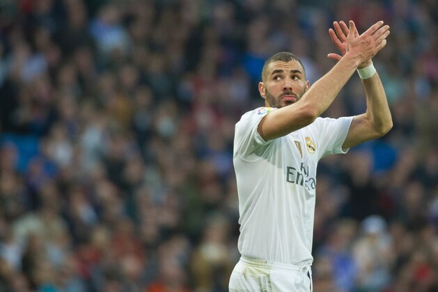 Real Madrid's French forward Karim Benzema greets supporters as he leaves the pitch during the Spanish league football match Real Madrid CF vs Getafe CF at the Santiago Bernabeu stadium in Madrid on December 5, 2015. AFP PHOTO / CURTO DE LA TORRE / AFP / CURTO DE LA TORRE        (Photo credit should read CURTO DE LA TORRE/AFP/Getty Images)