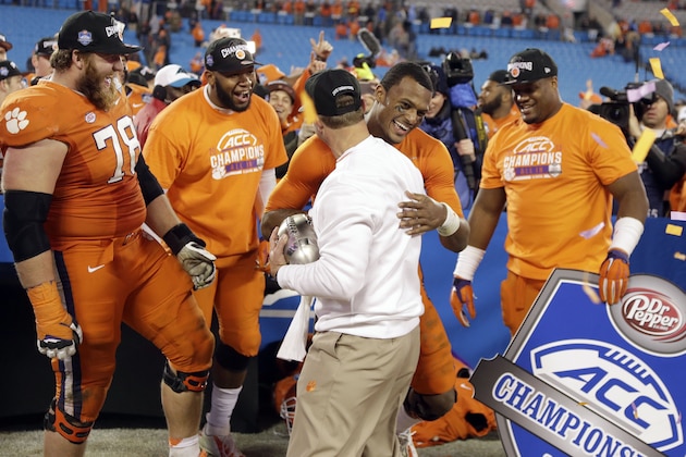 Clemson quarterback Deshaun Watson hugs coach Dabo Swinney after Clemson defeated North Carolina 45-37 in the Atlantic Coast Conference championship NCAA college football game in Charlotte, N.C., early Sunday, Dec. 6, 2015. (AP Photo/Bob Leverone)