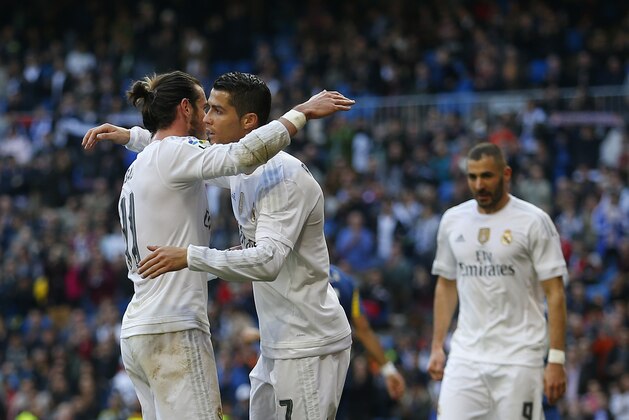 Real Madrid's Gareth Bale, left, celebrates with teammates Cristiano Ronaldo, centre, and Karim Benzema, right, after scoring their side's third goal against Getafe during the Spanish La Liga soccer match between Real Madrid and Getafe at the Santiago Bernabeu stadium in Madrid, Saturday, Dec. 5, 2015. Benzema scored twice and Ronaldo and Bale scored once each in Real Madrid's 4-1 victory (AP Photo/Francisco Seco)
