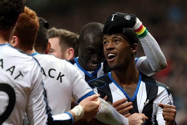 Newcastle United's Georginio Wijnaldum, right, celebrates his goal with his teammates during the English Premier League soccer match between Newcastle United and Liverpool at St James' Park, Newcastle, England, Sunday, Dec. 6, 2015. (AP Photo/Scott Heppell)