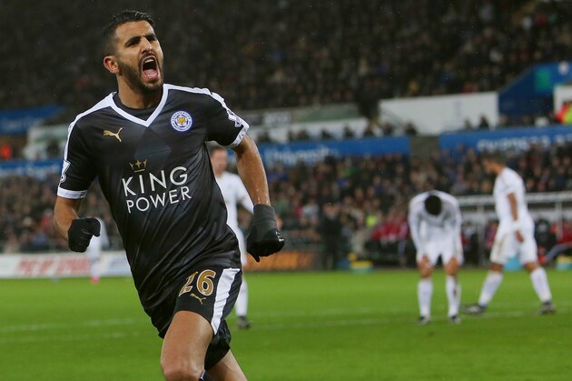 Leicester City's Algerian midfielder Riyad Mahrez celebrates after scoring his third goal during the English Premier League football match between Swansea City and Leicester City at The Liberty Stadium in Swansea, south Wales on December 5, 2015.       AFP PHOTO / GEOFF CADDICK

RESTRICTED TO EDITORIAL USE. No use with unauthorized audio, video, data, fixture lists, club/league logos or 'live' services. Online in-match use limited to 75 images, no video emulation. No use in betting, games or single club/league/player publications. / AFP / GEOFF CADDICK        (Photo credit should read GEOFF CADDICK/AFP/Getty Images)