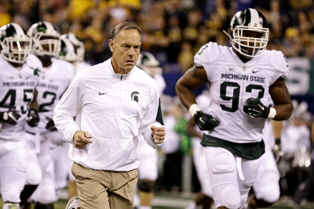 Michigan State coach Mark Dantonio leads his team onto the field for the Big Ten Conference championship NCAA college football game against Iowa Saturday, Dec. 5, 2015, in Indianapolis. (AP Photo/Michael Conroy)