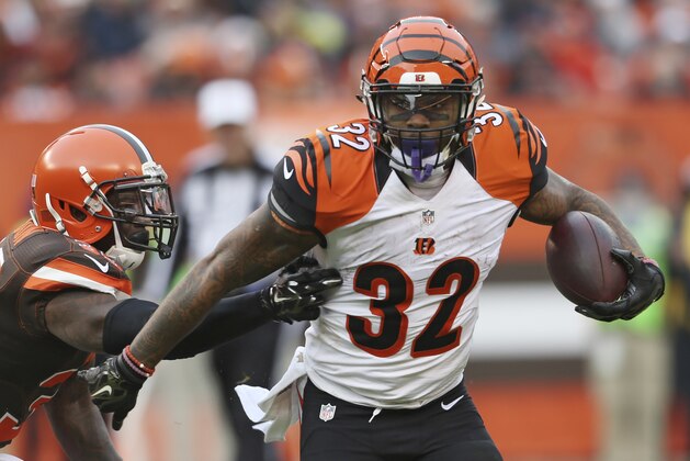 Cincinnati Bengals running back Jeremy Hill (32) breaks a tackle from Cleveland Browns free safety Tashaun Gipson (39) in the second half of an NFL football game, Sunday, Dec. 6, 2015, in Cleveland. (AP Photo/Ron Schwane)