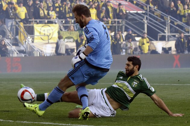 Portland Timbers midfielder Diego Valeri, right, of Argentina, scores a goal against Columbus Crew goalkeeper Steve Clark during the first half of the MLS Cup championship soccer game Sunday, Dec. 6, 2015, in Columbus, Ohio. (AP Photo/Paul Vernon)