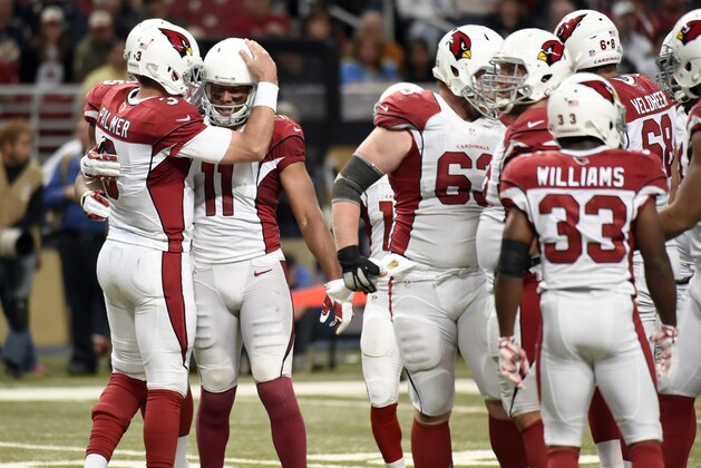 Arizona Cardinals wide receiver Larry Fitzgerald (11) is congratulated by quarterback Carson Palmer after catching a pass during the fourth quarter of an NFL football game against the St. Louis Ram on Sunday, Dec. 6, 2015, in St. Louis. With the reception, Fitzgerald has surpassed Andre Johnson as the youngest player to reach 1,000 career receptions in NFL history. (AP Photo/L.G. Patterson)