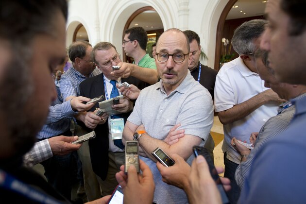 New York Yankees general manager Brian Cashman, center, speaks to member of the media as he attends the baseball general managers' meetings, Wednesday, Nov. 11, 2015, in Boca Raton, Fla. The Yankees have traded infielder Jose Pirela to the San Diego Padres for right-hander Ronald Herrera in the first deal of the general managers' meetings. (AP Photo/Wilfredo Lee)