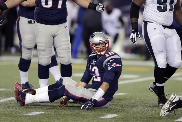 New England Patriots quarterback Tom Brady sits on the turf during the first half of an NFL football game against the Philadelphia Eagles, Sunday, Dec. 6, 2015, in Foxborough, Mass. (AP Photo/Charles Krupa)