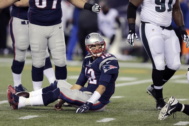 New England Patriots quarterback Tom Brady sits on the turf during the first half of an NFL football game against the Philadelphia Eagles, Sunday, Dec. 6, 2015, in Foxborough, Mass. (AP Photo/Charles Krupa)