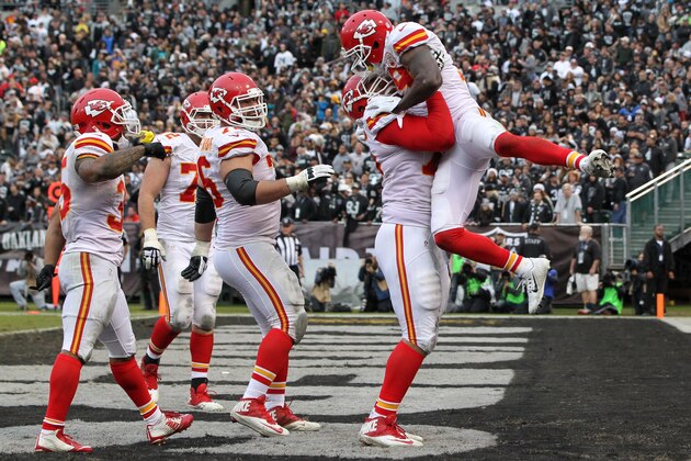 OAKLAND, CA - DECEMBER 06:  Jeremy Maclin #19 of the Kansas City Chiefs celebrates with Jah Reid #75 after a 13-yard touchdown pass from Alex Smith #11 during their NFL game against the Oakland Raiders at O.co Coliseum on December 6, 2015 in Oakland, California.  (Photo by Jason O. Watson/Getty Images)