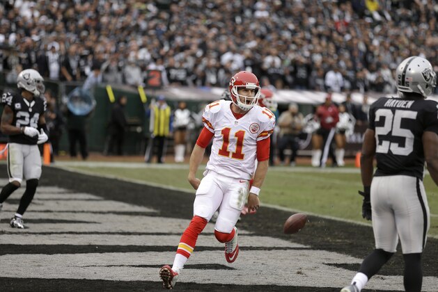 Kansas City Chiefs quarterback Alex Smith (11) reacts after running for a touchdown against the Oakland Raiders during the first half of an NFL football game in Oakland, Calif., Sunday, Dec. 6, 2015. (AP Photo/Ben Margot)
