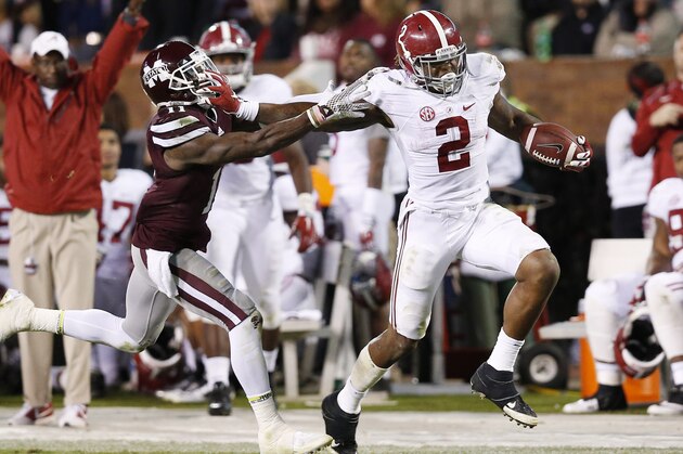 Alabama running back Derrick Henry (2) fights offs an attempted tackle by Mississippi State defensive back Kivon Coman (11) on his way to a 65-yard touchdown during the second half of an NCAA college football game in Starkville, Miss., Saturday, Nov. 14, 2015. No. 3 Alabama won 31-6. (AP Photo/Rogelio V. Solis)