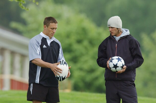 MANCHESTER - MAY 7:  Jonny Wilkinson (L) of England and the Newcastle Falcons shows David Beckham of England and Real Madrid how to hold a rugby ball during the latest Adidas campaign on location at Mottram Hall on May 7, 2003 in Manchester, England. (Photo by Stu Forster/Getty Images for Adidas)