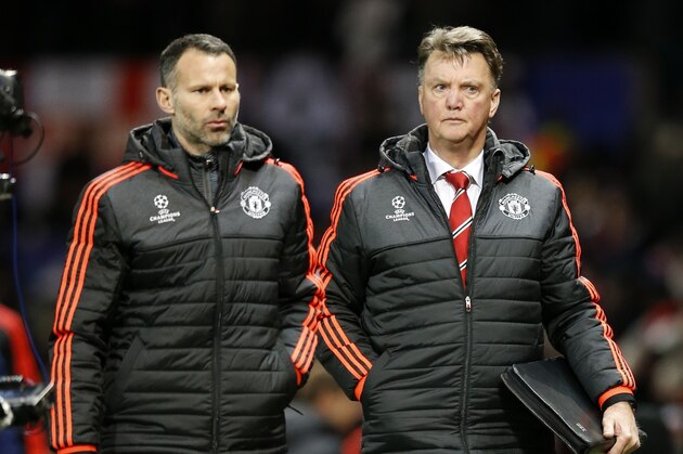 Manchester United's manager Louis van Gaal, right, and Ryan Giggs assistant manager leave the pitch after the Champions League group B soccer match between Manchester United and PSV Eindhoven at Old Trafford Stadium in Manchester, England, Wednesday, Nov. 25, 2015.The match ended 0-0. (AP Photo/Jon Super)