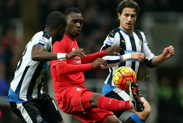 Liverpool's Christian Benteke, center, vies for the ball with Newcastle United's Chancel Mbemba, left, and Daryl Janmaat, right, during the English Premier League soccer match between Newcastle United and Liverpool at St James' Park, Newcastle, England, Sunday, Dec. 6, 2015. (AP Photo/Scott Heppell)