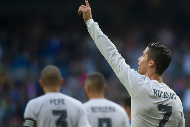 Real Madrid's Portuguese forward Cristiano Ronaldo gestures as he celebrates a goal during the Spanish league football match Real Madrid CF vs Getafe CF at the Santiago Bernabeu stadium in Madrid on December 5, 2015. AFP PHOTO / CURTO DE LA TORRE / AFP / CURTO DE LA TORRE        (Photo credit should read CURTO DE LA TORRE/AFP/Getty Images)