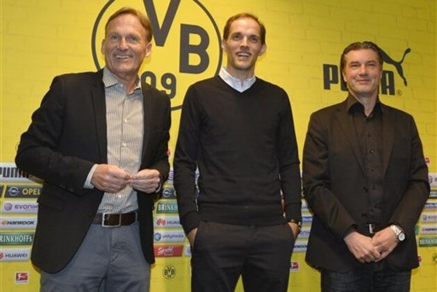 Borussia Dortmund's new head coach Thomas Tuchel, center, is presented by CEO Han-Joachim Watzke, left, and sporting manager Michael Zorc, right, at the stadium in Dortmund, Germany, Wednesday, June 3, 2015. Tuchel follows Juergen Klopp, who left the German first division soccer club BVB after seven years. (AP Photo/Martin Meissner)